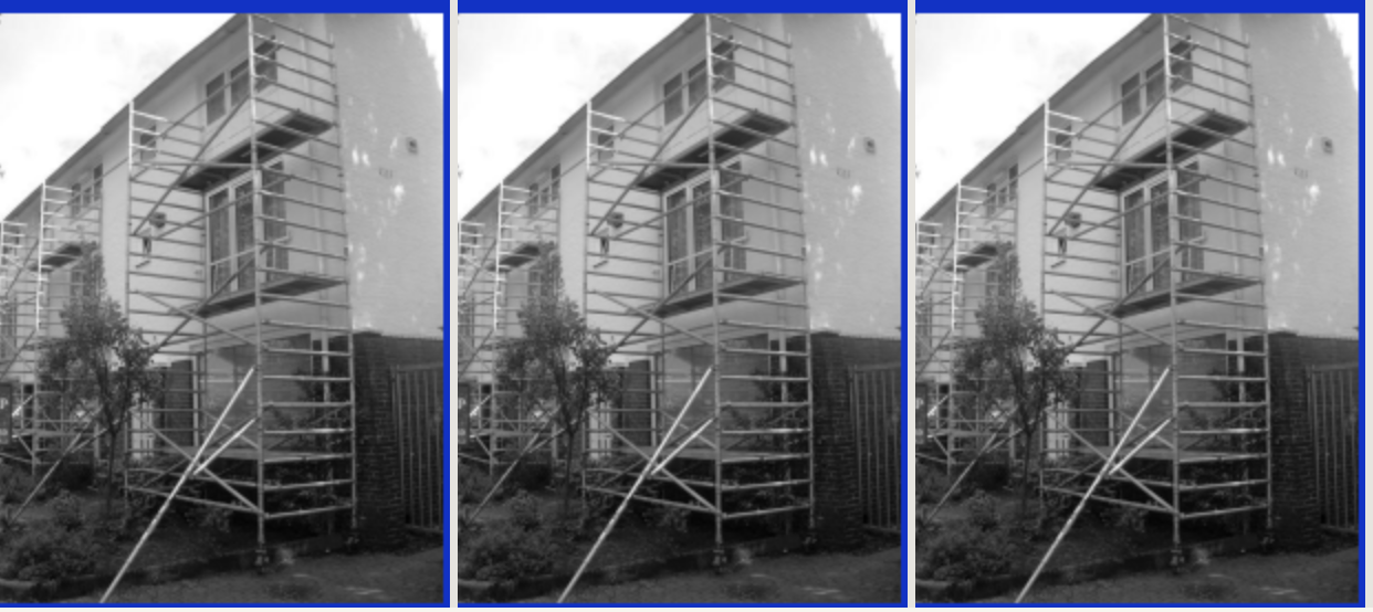 Historical photo of houses surrounded by scaffolding